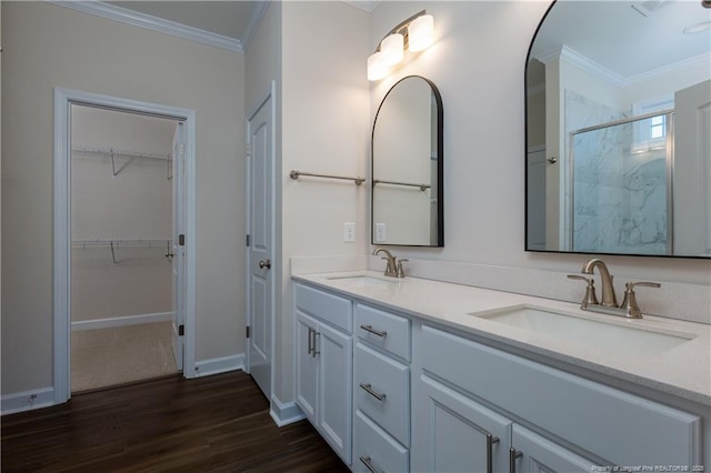 bathroom featuring vanity, crown molding, walk in shower, and hardwood / wood-style floors