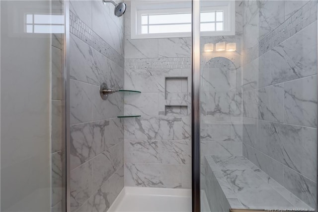 bathroom with a shower with shower door