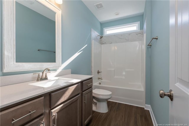 full bathroom featuring vanity, shower / washtub combination, toilet, and hardwood / wood-style flooring