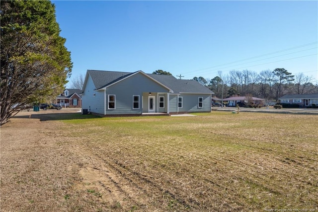 rear view of property featuring a yard