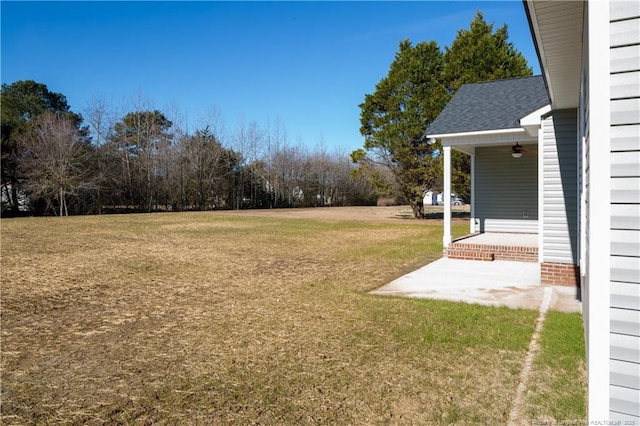 view of yard with a patio area and ceiling fan