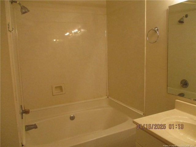 bathroom featuring washtub / shower combination and vanity