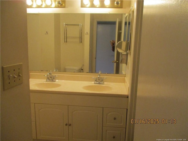 bathroom featuring toilet and vanity