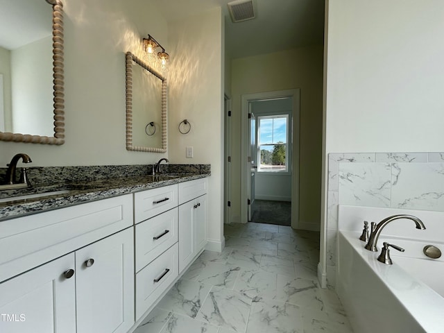 full bathroom featuring marble finish floor, double vanity, visible vents, a sink, and baseboards