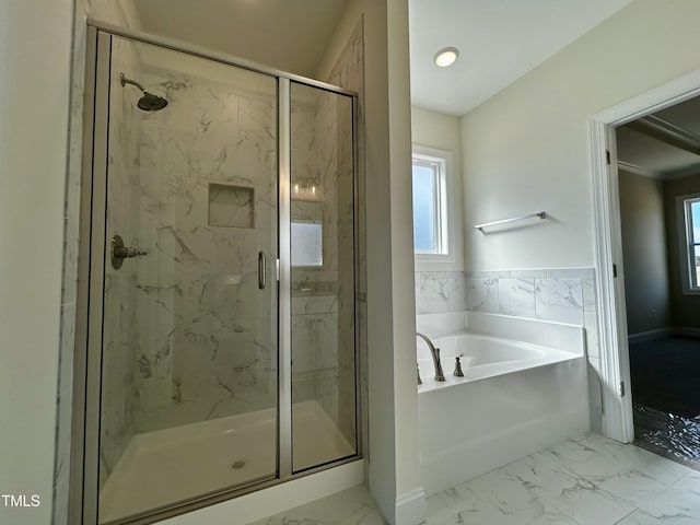 bathroom featuring marble finish floor, a stall shower, and a bath