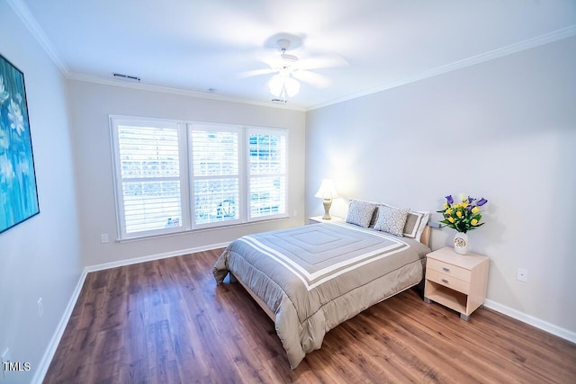 bedroom with ornamental molding, dark hardwood / wood-style floors, and ceiling fan