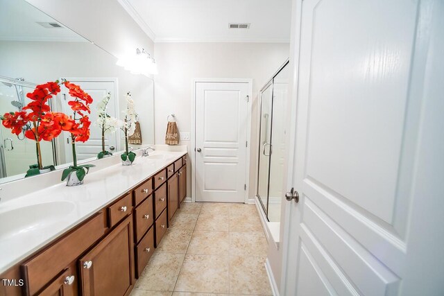 bathroom with tile patterned flooring, ornamental molding, vanity, and walk in shower