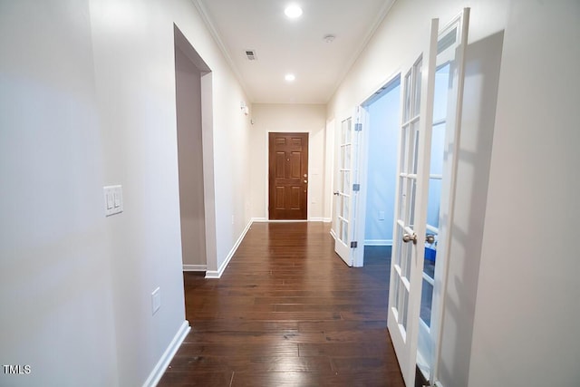 corridor with french doors, dark hardwood / wood-style floors, and crown molding