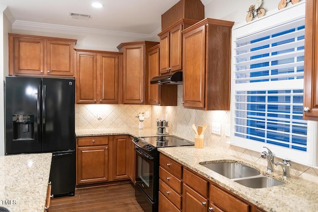 kitchen with sink, light stone counters, tasteful backsplash, ornamental molding, and black appliances