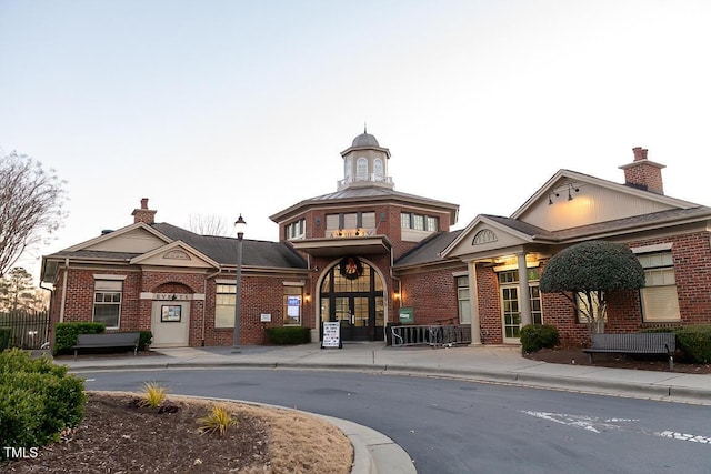 view of outdoor building at dusk