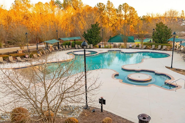 view of swimming pool featuring a community hot tub and a patio area