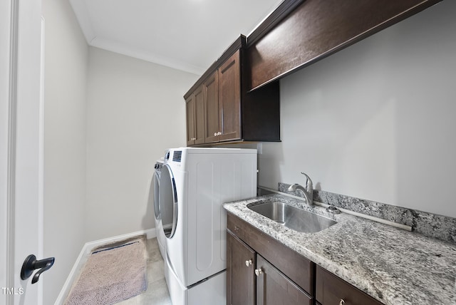 washroom with cabinets, sink, independent washer and dryer, light tile patterned floors, and crown molding