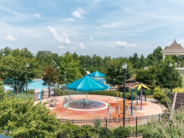 view of home's community featuring a pool and a patio