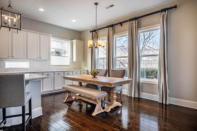 dining area with an inviting chandelier, dark wood-type flooring, and breakfast area