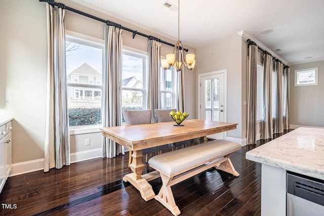 dining space with plenty of natural light and dark hardwood / wood-style flooring