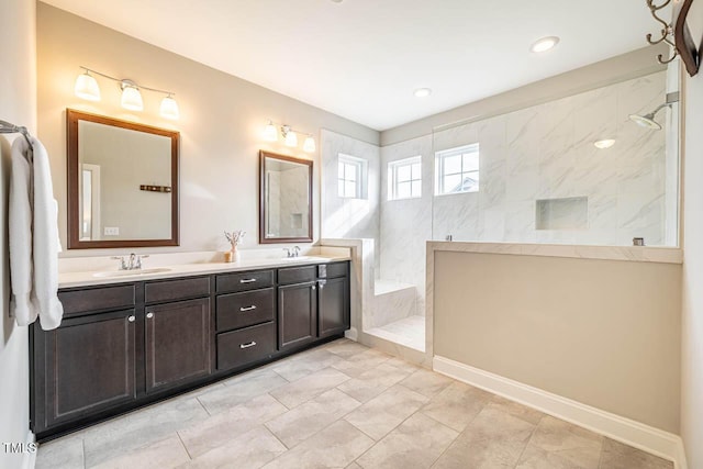 bathroom with vanity and tiled shower