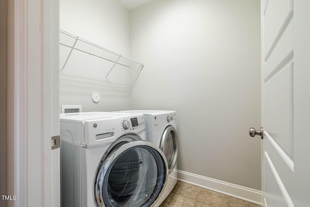 clothes washing area featuring washing machine and dryer