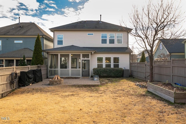 back of house featuring a lawn, a sunroom, a patio, and central air condition unit