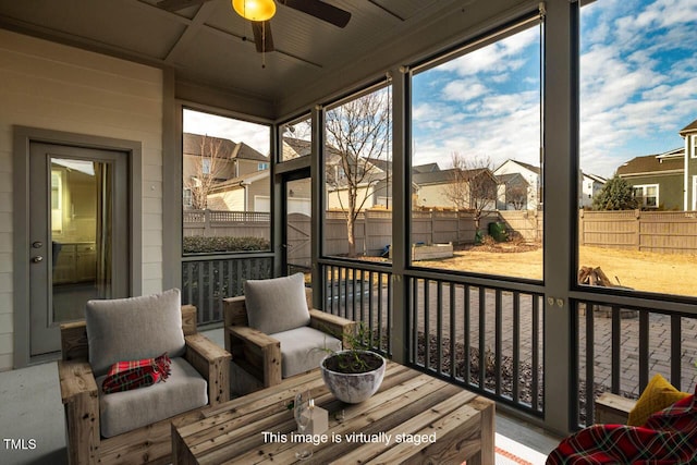 sunroom featuring ceiling fan