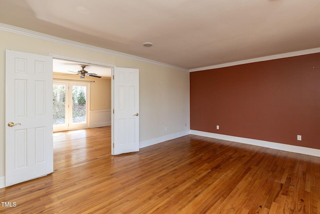 unfurnished room featuring light wood finished floors, baseboards, and ornamental molding