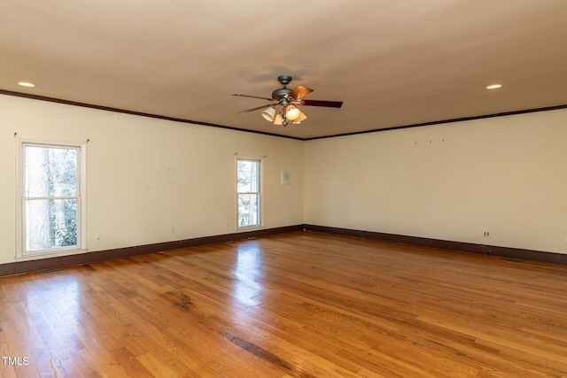 unfurnished room featuring wood finished floors, baseboards, and ornamental molding