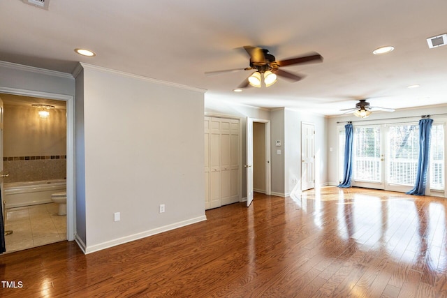 unfurnished living room featuring recessed lighting, crown molding, baseboards, and wood finished floors