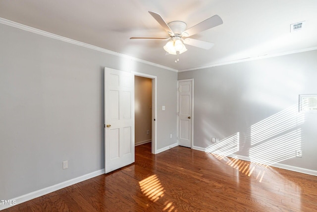 unfurnished room featuring visible vents, baseboards, and wood finished floors