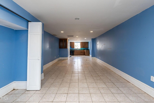 unfurnished room with light tile patterned floors, recessed lighting, and baseboards