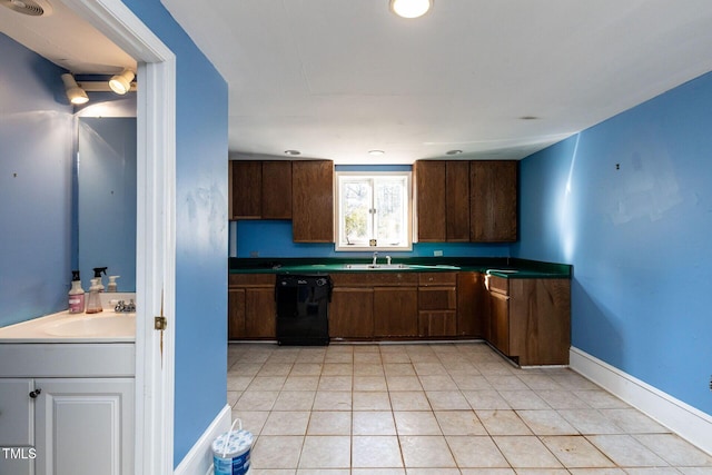 kitchen with a sink, baseboards, black dishwasher, and dark countertops