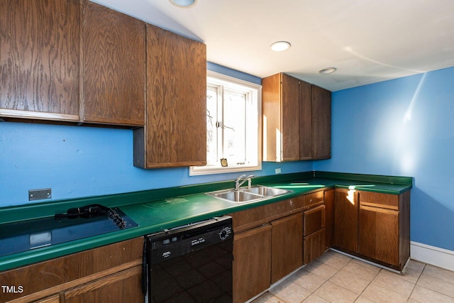 kitchen featuring dark countertops, baseboards, light tile patterned floors, black appliances, and a sink