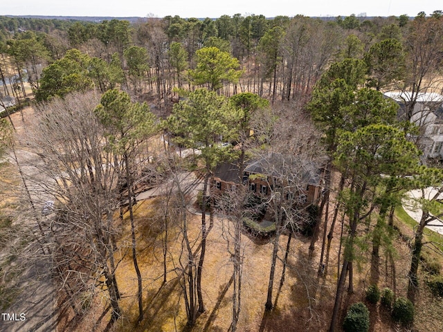 drone / aerial view featuring a wooded view