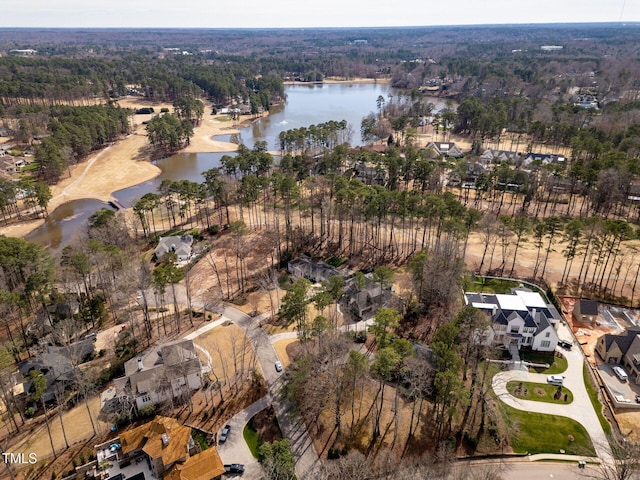 aerial view with a forest view and a water view