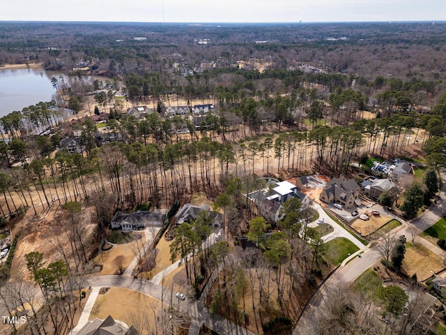 birds eye view of property with a forest view and a water view