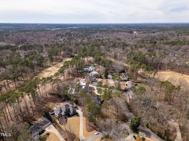 drone / aerial view featuring a wooded view