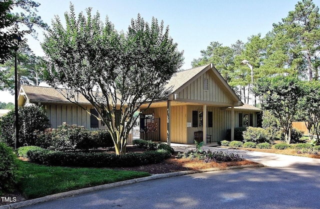 view of front facade featuring board and batten siding and driveway