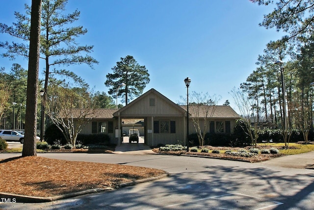 view of property featuring an attached carport and concrete driveway