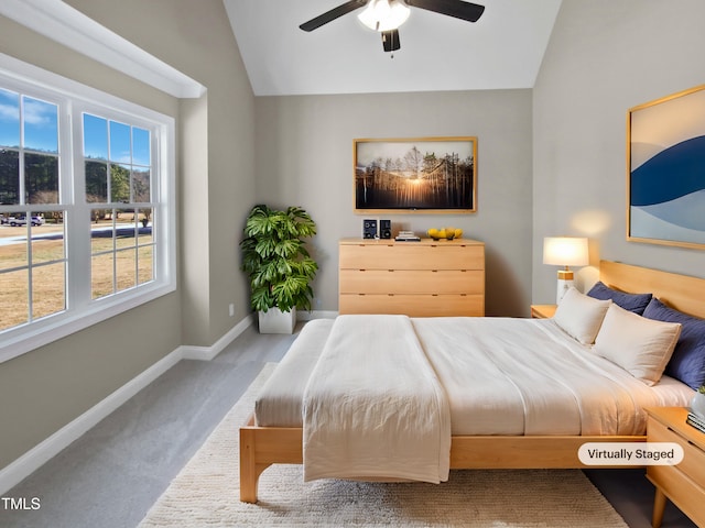 carpeted bedroom featuring ceiling fan and lofted ceiling