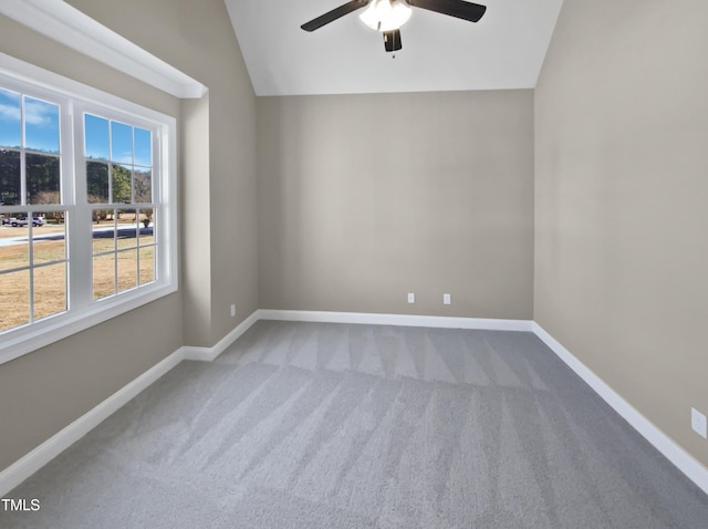 carpeted empty room with ceiling fan and lofted ceiling