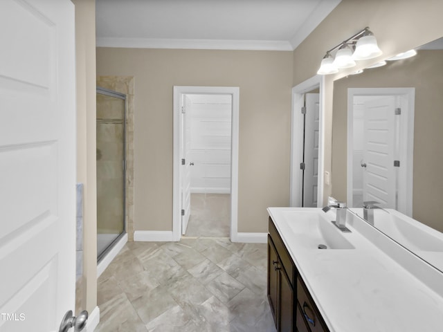 bathroom featuring vanity, a shower with door, and crown molding