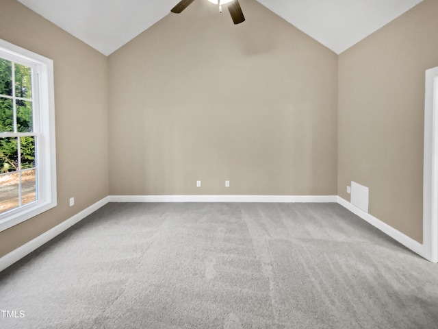 carpeted empty room with ceiling fan and vaulted ceiling