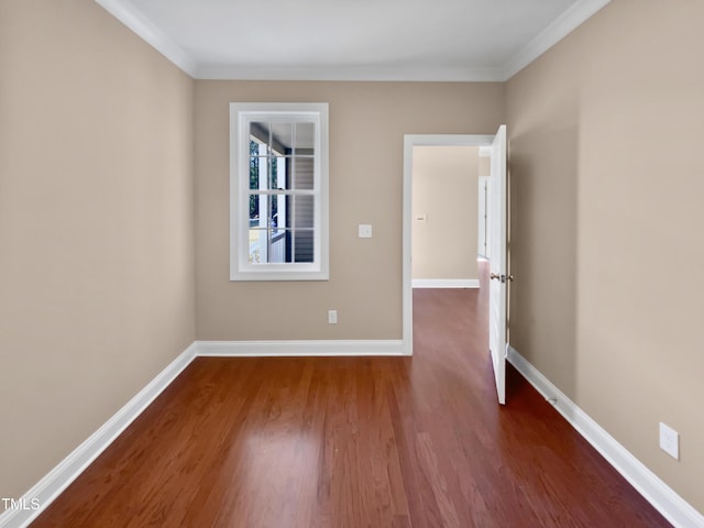 spare room with dark hardwood / wood-style floors and ornamental molding