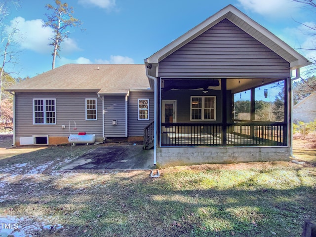 back of house featuring ceiling fan, covered porch, and a yard