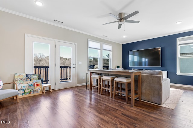 living room featuring ceiling fan, dark hardwood / wood-style flooring, and ornamental molding