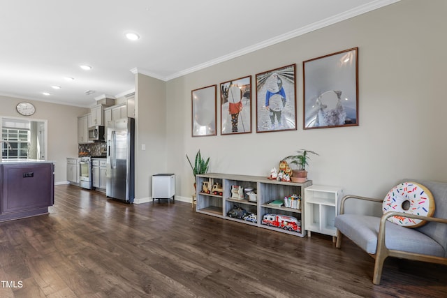 living area featuring dark hardwood / wood-style flooring, ornamental molding, and sink