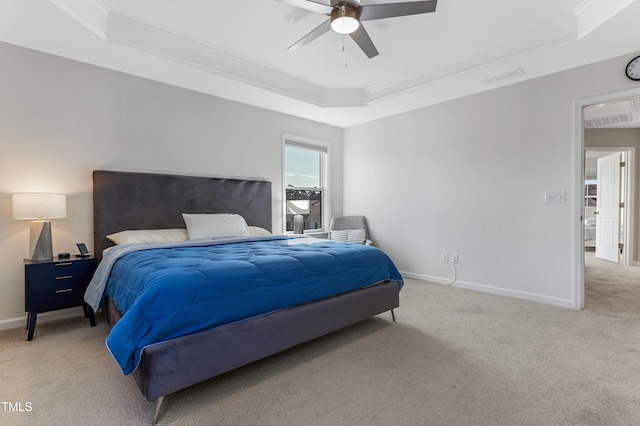 bedroom featuring ceiling fan, light colored carpet, a tray ceiling, and ornamental molding