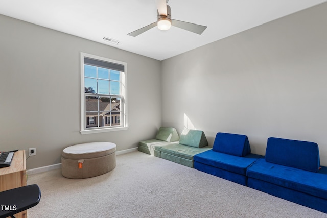 sitting room featuring ceiling fan and carpet flooring