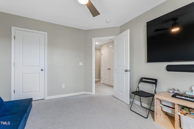 living area featuring light carpet and ceiling fan