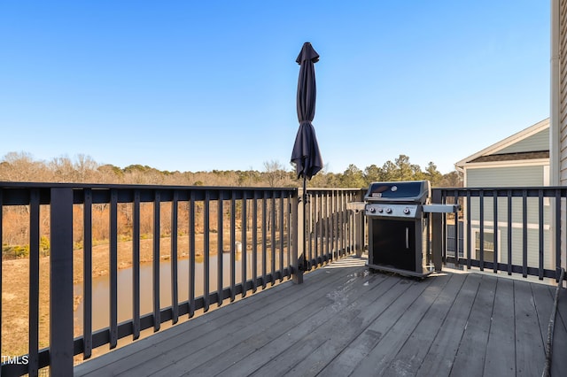 wooden deck with a grill