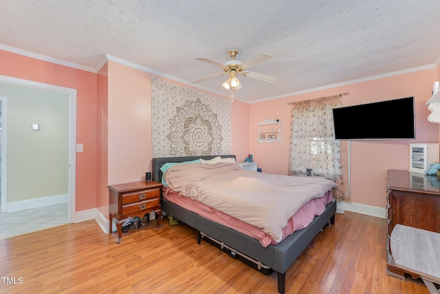 bedroom featuring ornamental molding, a textured ceiling, ceiling fan, and wood-type flooring