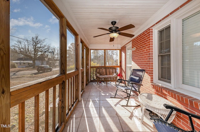 sunroom / solarium featuring ceiling fan